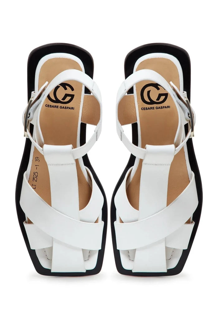 A pair of stylish white ankle cuff sandals with a flat sole design, perfect for women's summer footwear.