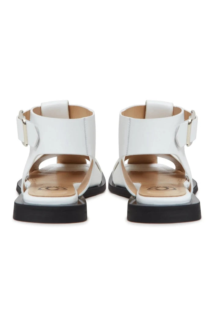 A trendy and comfortable pair of women's ankle cuff sandals with a flat sole in classic white, perfect for summer footwear.