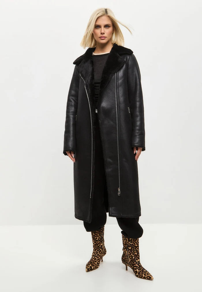 A fashionable black shearling coat, reversible and trendy faux shearling jacket for women's winter outerwear.