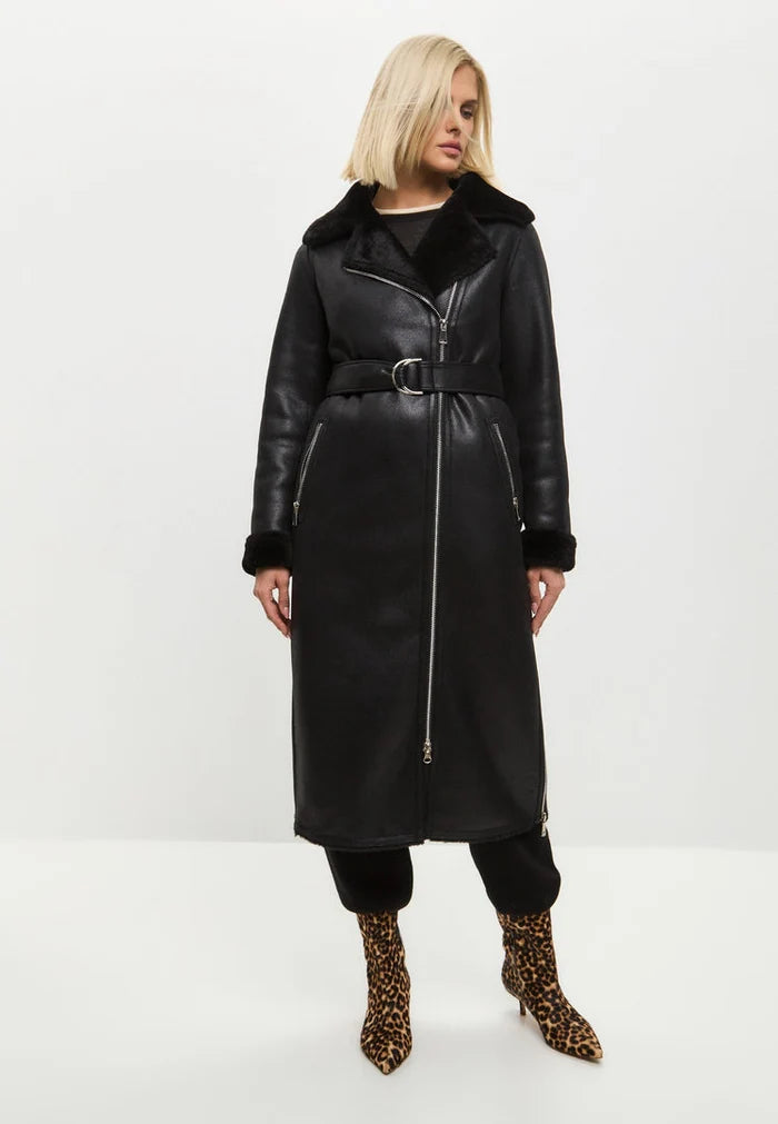 A stylish black shearling coat, reversible and cozy faux shearling jacket for women's winter outerwear. Stay warm and on-trend with this trendy shearling clothing essential.
