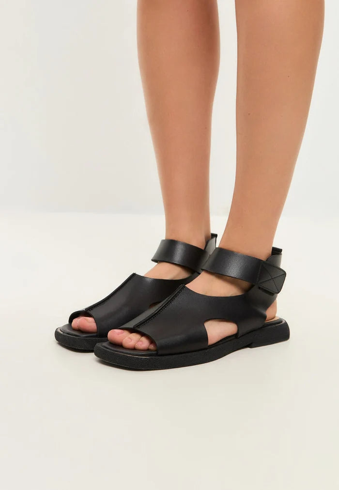 A sleek pair of black leather ankle strap sandals - the ultimate combination of style and comfort.