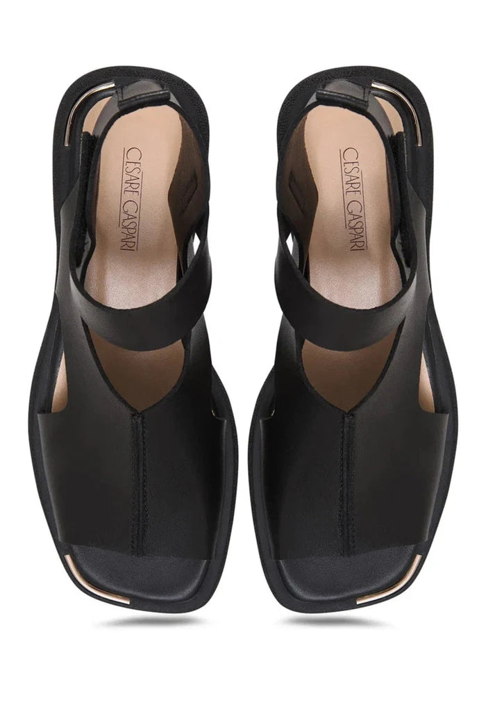 A pair of stylish black leather ankle strap sandals with a chic buckle detail.