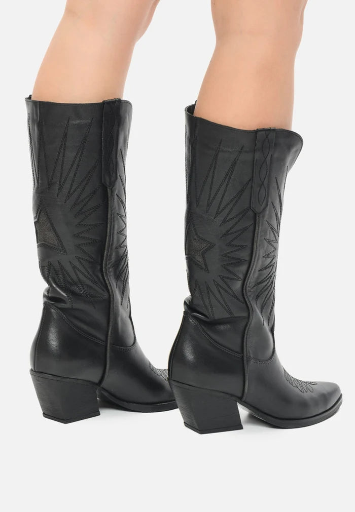 A close-up image of stylish black cowboy boots, featuring a pointed toe, block heel, and crafted from high-quality leather - perfect for any western-inspired outfit.