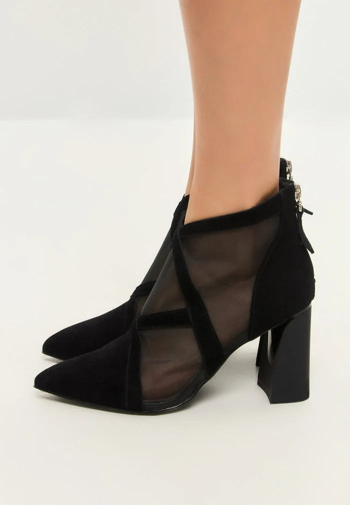A stylish pair of women's black sheer ankle boots, perfect for adding a touch of elegance to any outfit. The transparent mesh design gives these booties a unique and edgy look.