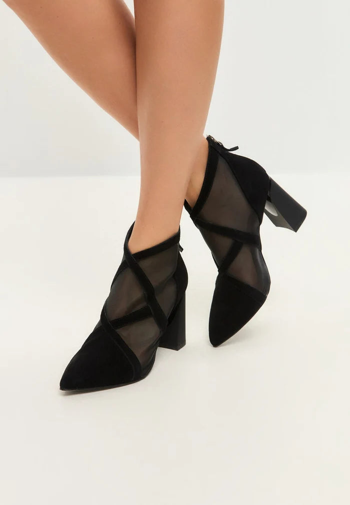 A stylish pair of women's black sheer ankle boots, also known as sheer booties or mesh ankle boots, featuring a transparent design.