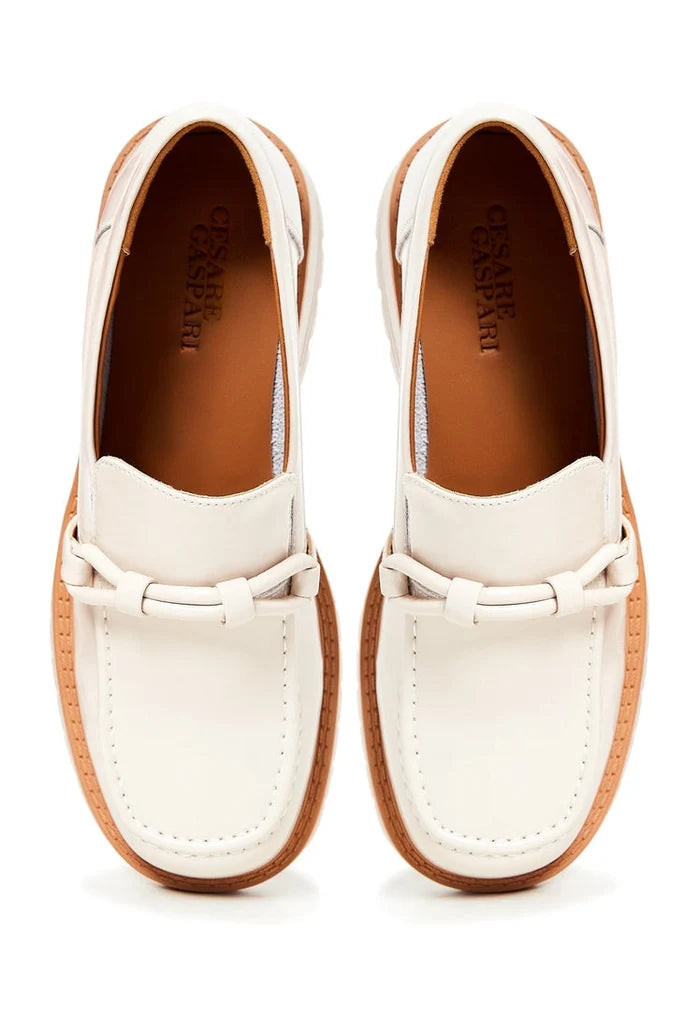 A trendy pair of beige block heels loafers for women, combining fashionable heels with comfortable loafers for a stylish look.