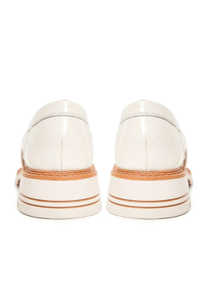 A stylish pair of women's block heels loafers in beige, fashionable and comfortable for all-day wear.