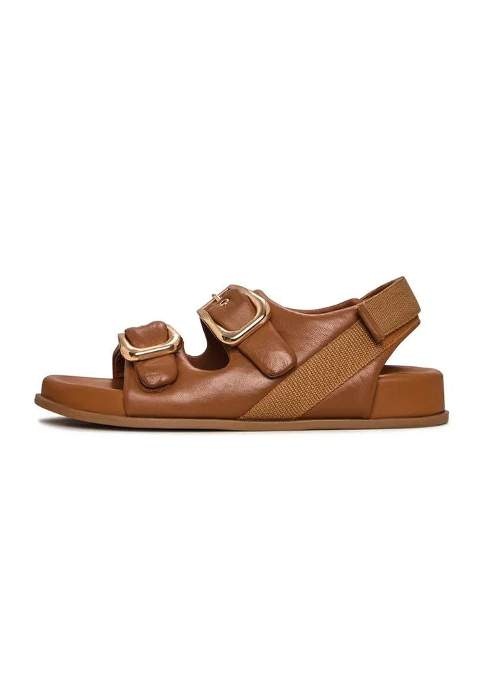 A stylish pair of beige wedge sandals with bold buckle detail for women, perfect for summer footwear.