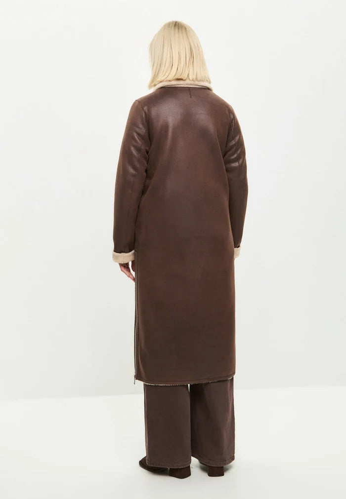 A stylish women's reversible shearling coat in brown faux fur, a versatile long shearling jacket perfect for cold weather, the ultimate brown faux fur outerwear for women.