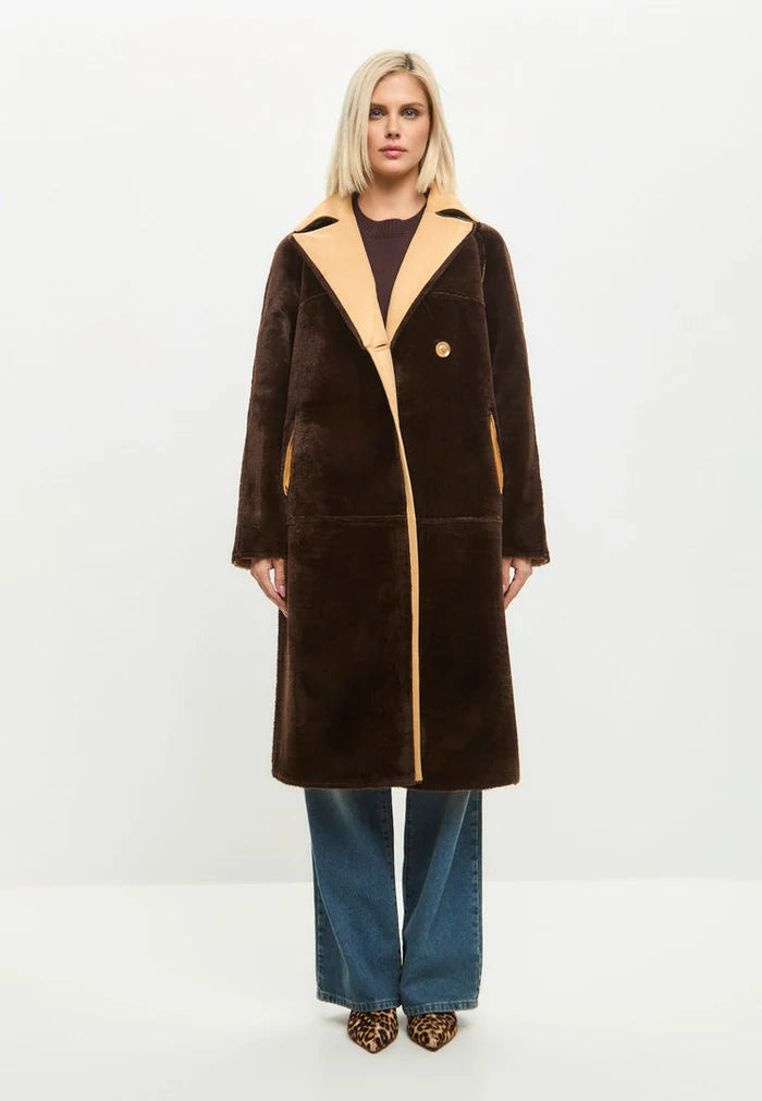 A stylish reversible faux fur light brown button-up women's fashion coat.