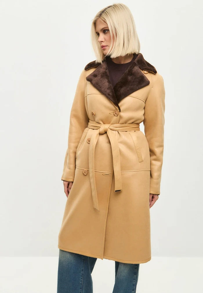 A stylish women's fashion coat featuring a reversible design with faux fur on one side and a light brown button-up jacket on the other.
