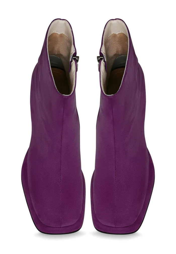A stylish pair of women's purple ankle boots with a casual block heel, perfect for adding a fashionable touch to any outfit.