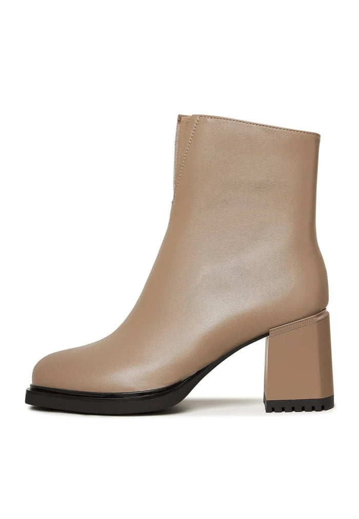 A stylish pair of beige high heeled ankle boots for women, perfect for adding a fashionable touch to any outfit.