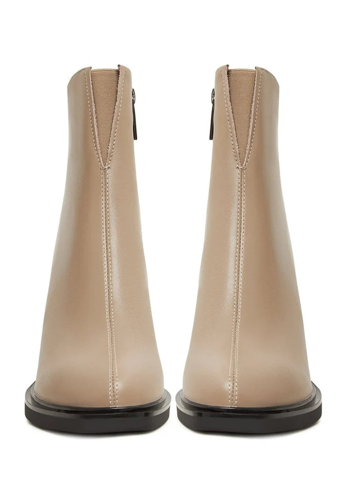 A trendy pair of beige high heeled ankle boots for women, perfect for adding a touch of style to any outfit.