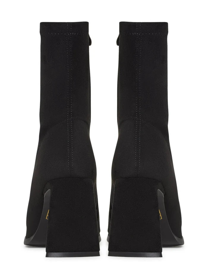 A pair of chic black suede ankle boots with a trendy block heel, perfect for casual wear.