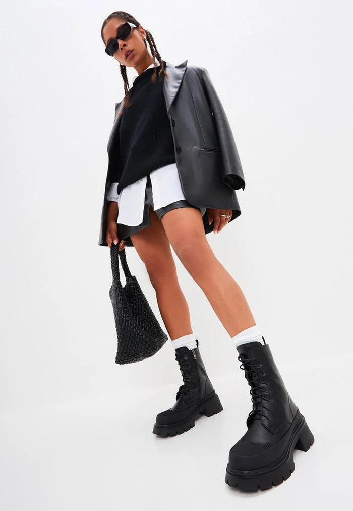 A pair of stylish black suede lace-up ankle boots, perfect for any casual outfit.