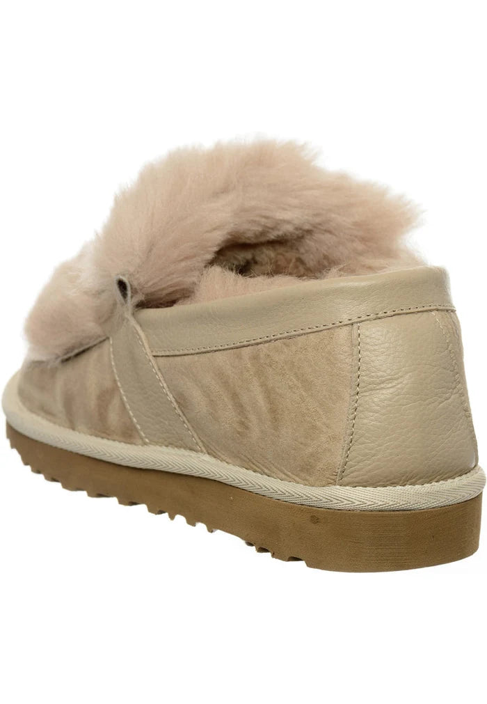 A stylish pair of beige fur lined chain loafers for women, ideal for anyone looking for designer footwear that seamlessly combines fashion and comfort.