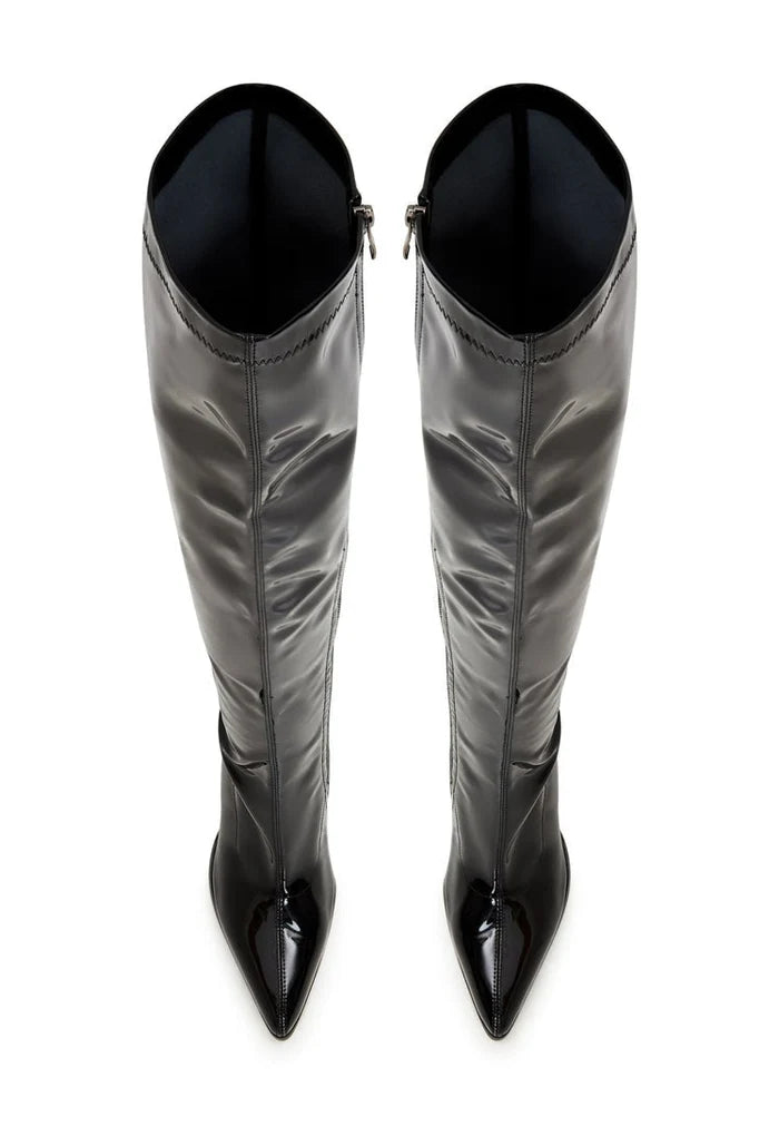 A stylish woman wearing black over-the-knee boots for chic comfort and fashionable look.