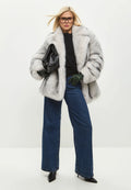 A fashionable and elegant white faux fur coat, the epitome of chic outerwear and trendy winter fashion.
