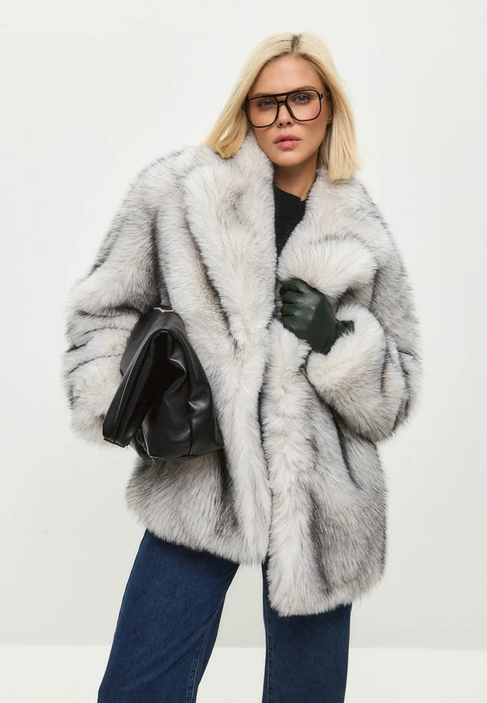 A stylish white faux fur coat, the perfect chic outerwear for the trendy winter fashionista.