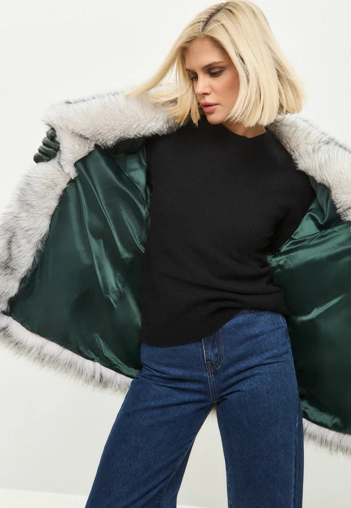 A stylish white faux fur coat, a chic outerwear choice for trendy winter fashion.