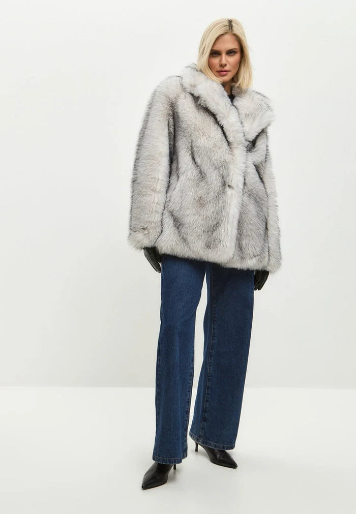 A stylish and trendy white faux fur coat, the perfect chic outerwear for the winter season, embracing the latest in faux fur fashion trends.