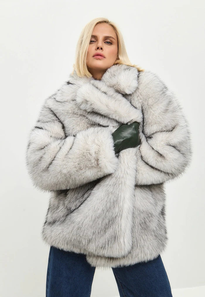 A stylish white faux fur coat, a chic and trendy choice for fashionable winter outerwear.