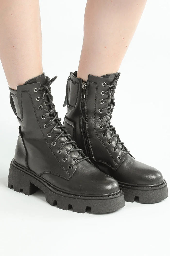 A stylish pair of chunky leather combat boots with laces, perfect for a rugged and trendy look.