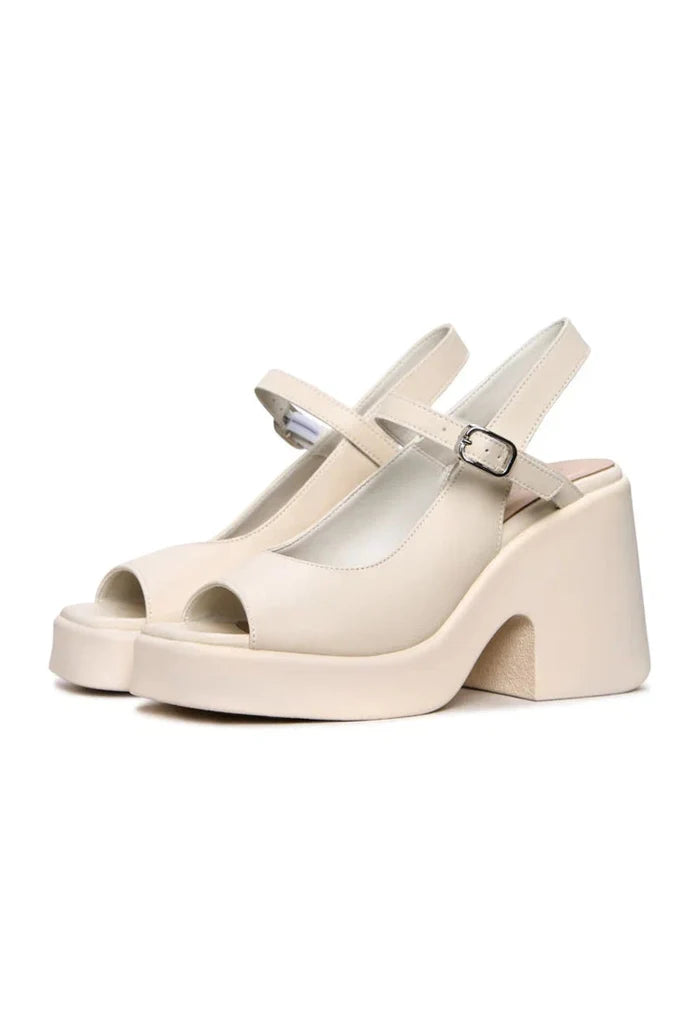 A pair of trendy women's chunky white platform sandals with a stylish and comfortable chunky heel.
