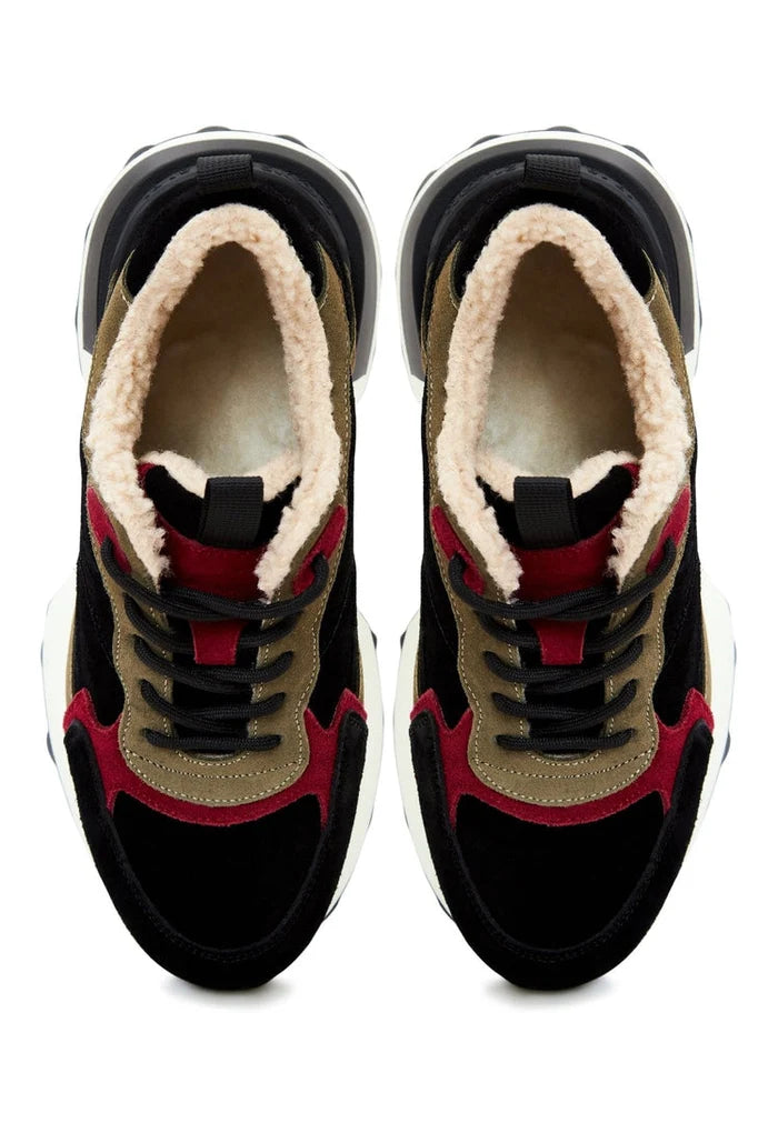 A woman wearing trendy brown chunky platform sneakers, a fashionable choice in platform footwear for women.