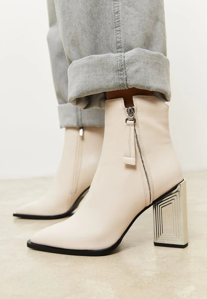 A chic pair of designer leather ankle boots in classic beige, perfect for women's fashion footwear.