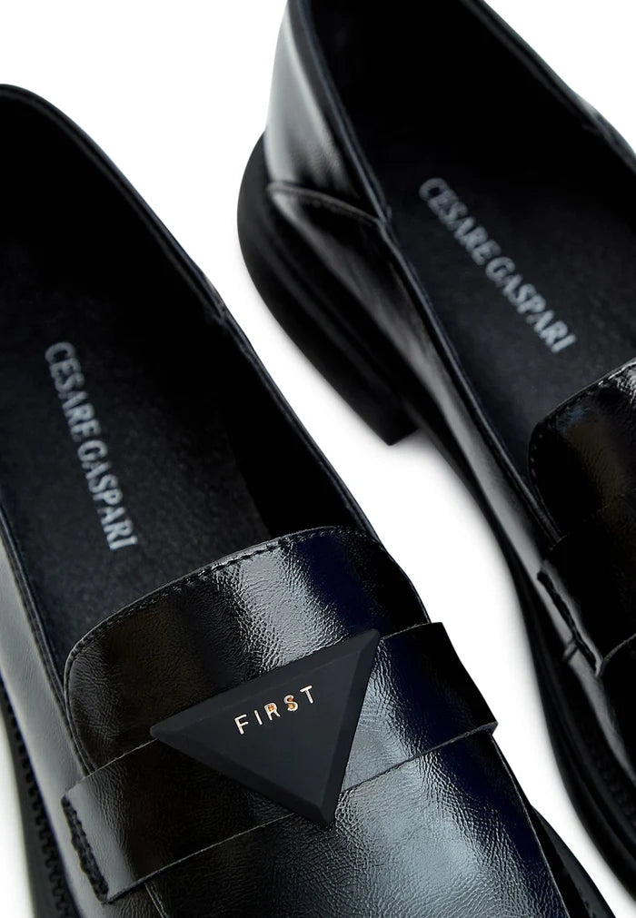 A sleek pair of black slip-on loafers, the perfect classic shoes for men.