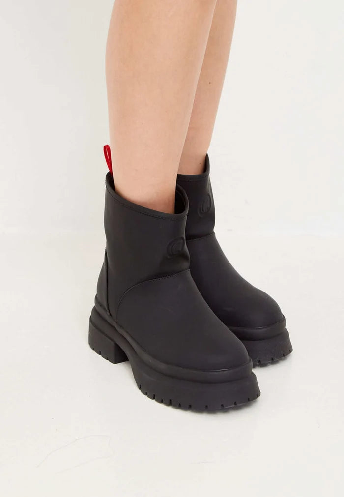 A pair of black pull-on winter boots, a classic choice for winter footwear.