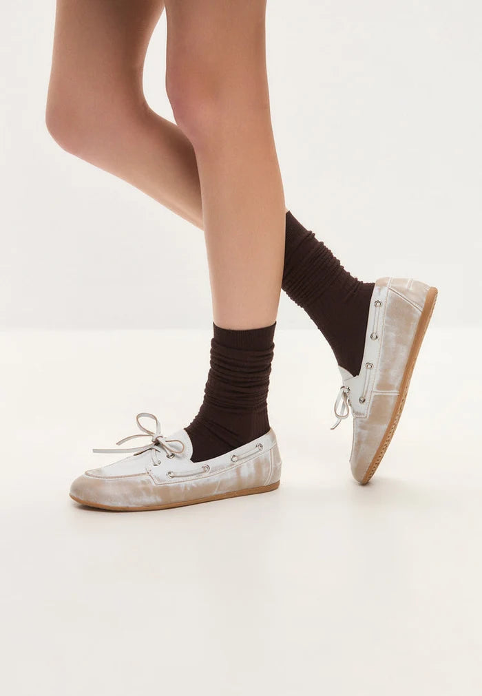 Vintage leather loafers, distressed white loafers, classic leather shoes, worn-effect loafers, and antique white footwear displayed in a row.
