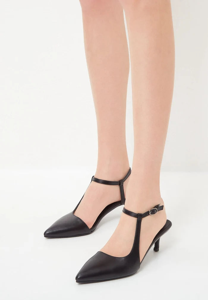 A pair of elegant luxe black pumps, a must-have luxury footwear item for those who enjoy designer heels and classic black shoes.
