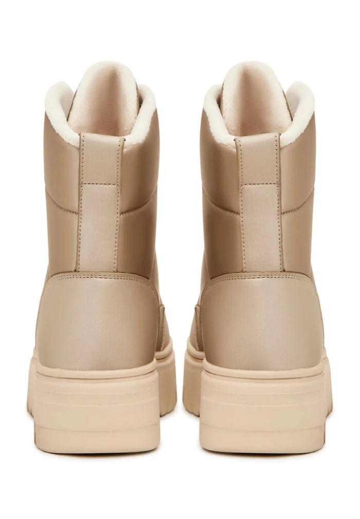 A stylish pair of beige winter boots, perfect for the cold weather - elegant and practical snow boots.