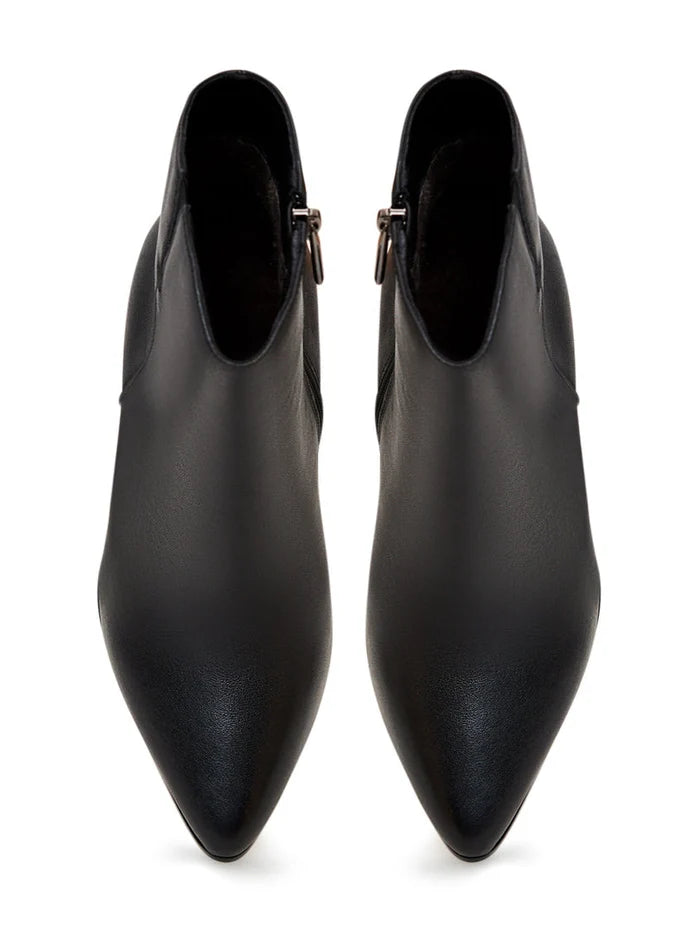 A trendy pair of fashionable black leather heeled boots with elevated heels, perfect for the fashion-forward individual.