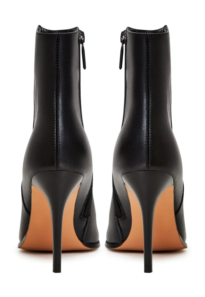 A fashionable pair of black leather heeled boots with elevated heels, perfect for a chic and stylish look.