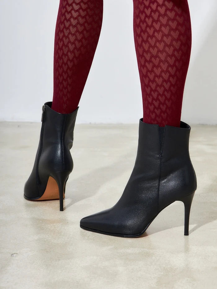 A stylish pair of black leather heeled boots with elevated heels, perfect for a fashionable footwear statement.