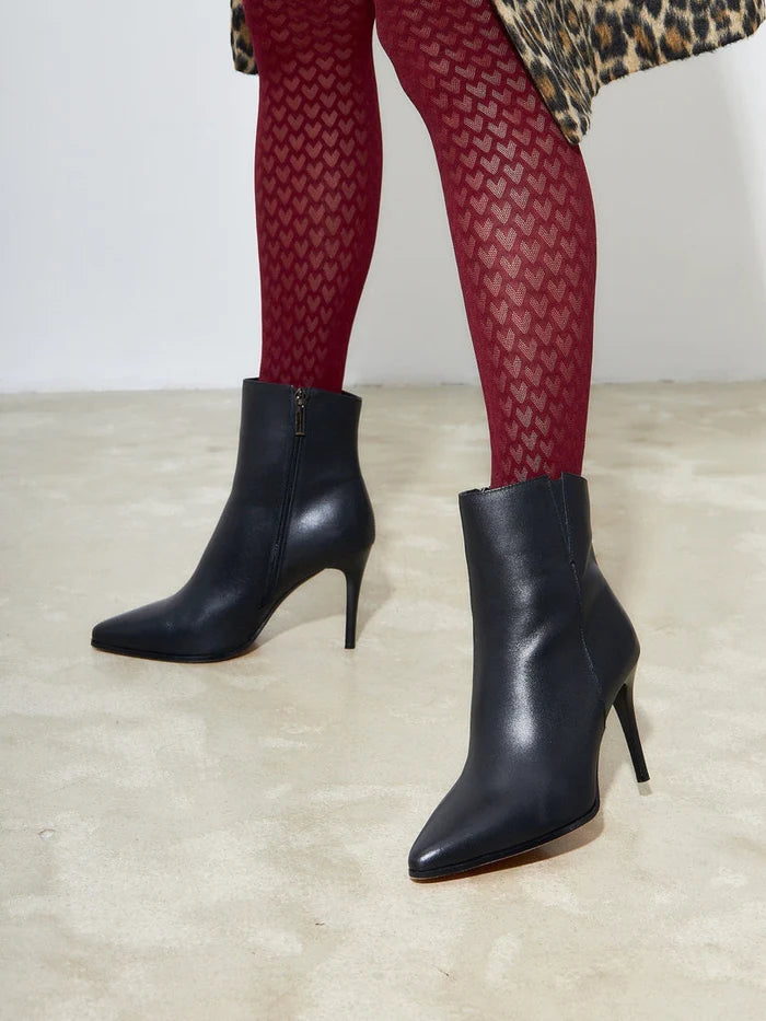 A stylish pair of black leather heeled boots with elevated heels, perfect for anyone looking for fashionable footwear.