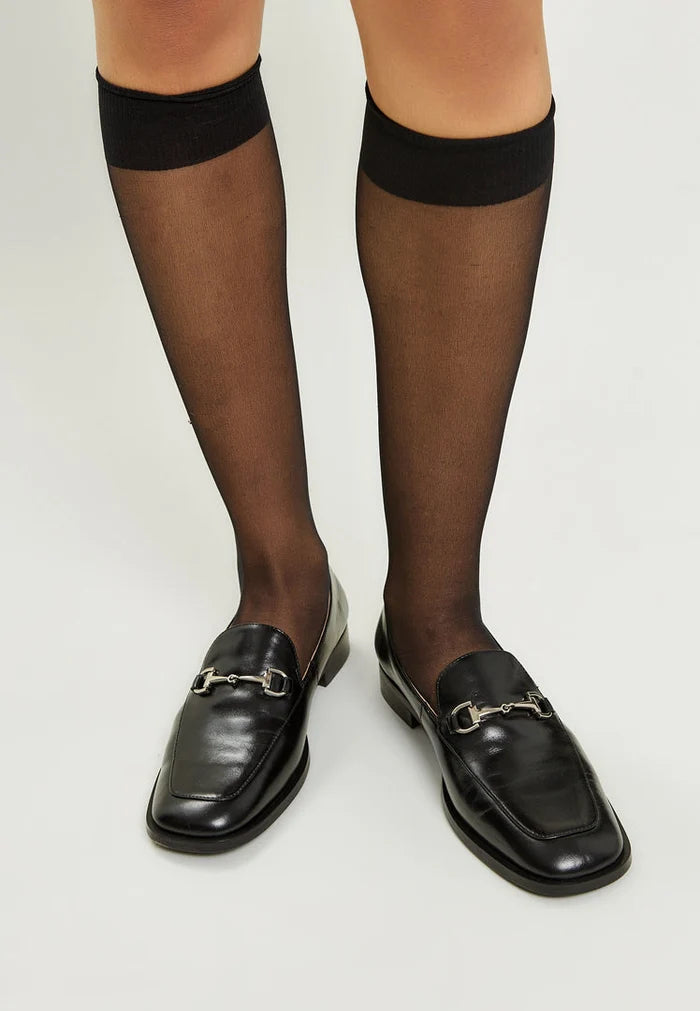 A stylish pair of black equestrian chic loafers, perfect for the fashion-forward individual looking for trendy equestrian footwear.