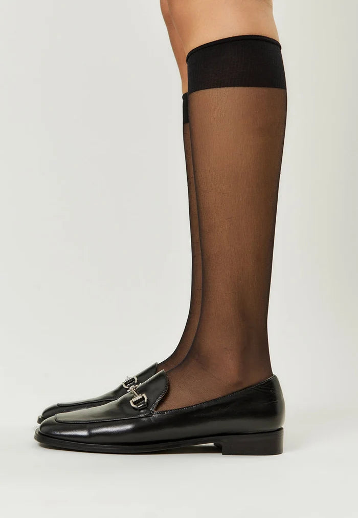 A pair of stylish black equestrian chic loafers, the perfect combination of fashionable and trendy equestrian footwear.