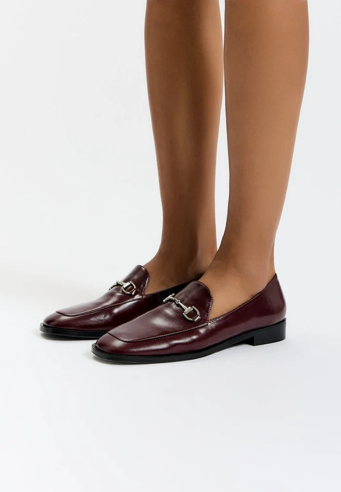 A stylish pair of equestrian chic Bordeaux loafers, perfect for those seeking fashionable equestrian footwear.