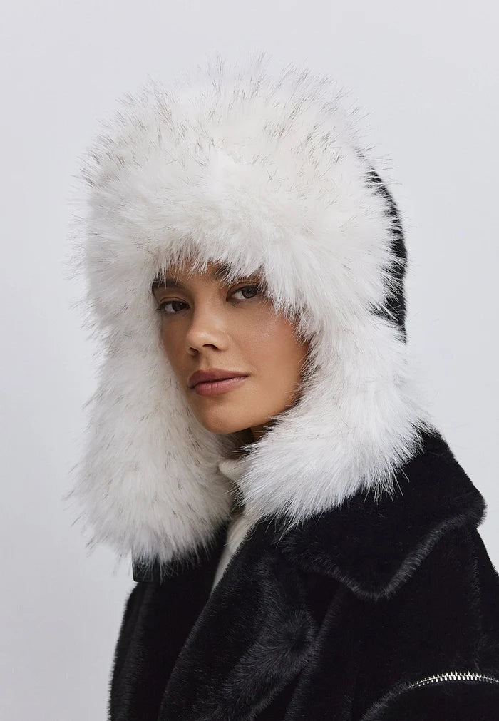 A model wearing a stylish black and white faux fur hat, perfect for winter fashion and showcasing the elegant design of the Irina faux fur hat.