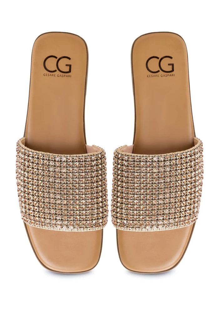 A pair of stylish gold Izzy flat sole women's slippers, perfect for a comfortable and fashionable look.