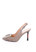 A close-up image of women's beige sparkle pumps with a glimmer buckle, perfect for adding a touch of glam to any outfit.