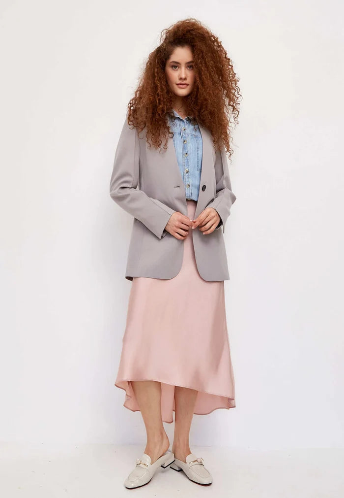 Trendy charm mules: A pair of elegant white mule shoes with a glossy charm, perfect for women's footwear fashion.
