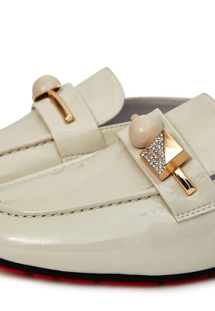 Trendy and elegant white mules with a glossy charm, perfect for women looking for stylish footwear.