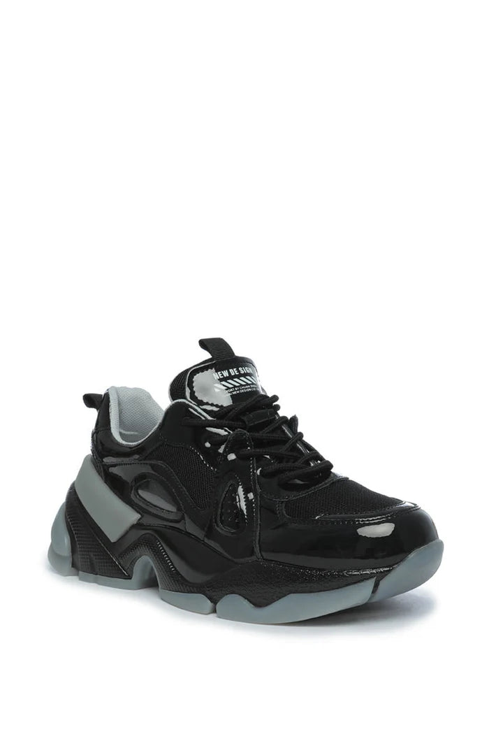 A stylish pair of chunky sole platform sneakers with a glossy finish, perfect for anyone looking to stay fashionable and on-trend.