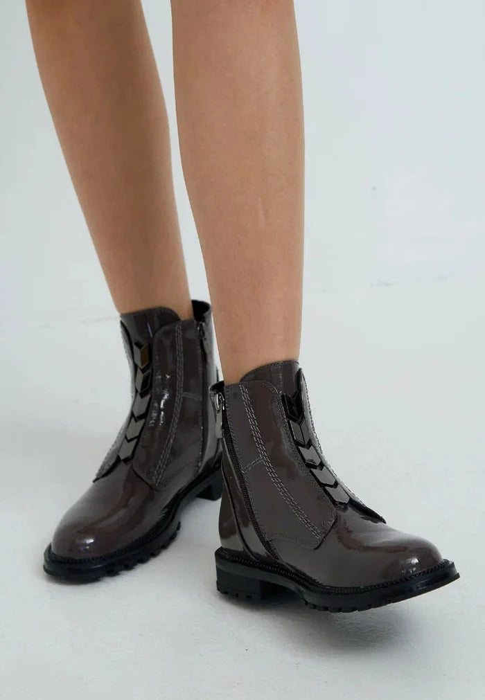 A stylish pair of brown ankle boots with a glossy finish and zip-up design - perfect for any outfit!